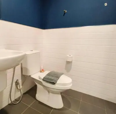 a bathroom with a white toilet and a sink at PRIME TOWN Phuket Resort & Wellness in Ban Rangeng