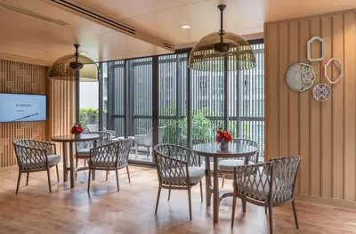 a dining room with tables and chairs and windows at THE BASE CENTRAL Phuket Shopping Mall Central Floresta in Ban Rangeng