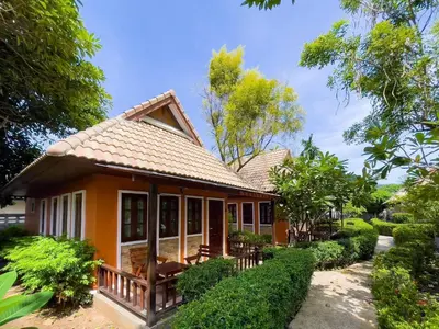 a small yellow house with a roof at Ongsantiphap villa resort in Ban Klang