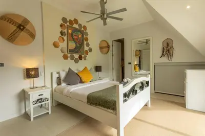 a bedroom with a bed and a ceiling fan at Brand new, designer furnishing, hot tub, gym, pool V98 in Rawai Beach