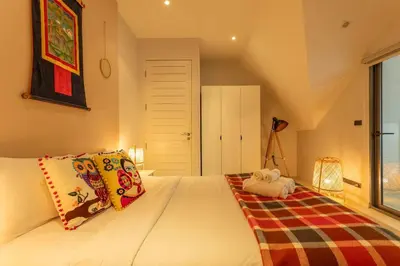 a bedroom with a bed with pillows on it at Brand new, designer furnishing, hot tub, gym, pool V98 in Rawai Beach