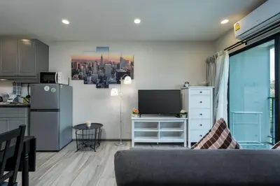 a living room with a couch and a kitchen at A1 The Title Nayang Стильная квартира in Nai Yang Beach