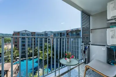 a balcony with a view of a pool at A1 The Title Nayang Стильная квартира in Nai Yang Beach