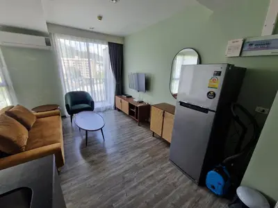 a living room with a refrigerator and a couch at The Deck Condo Patong 7th Fl Mountain View1 in Patong Beach