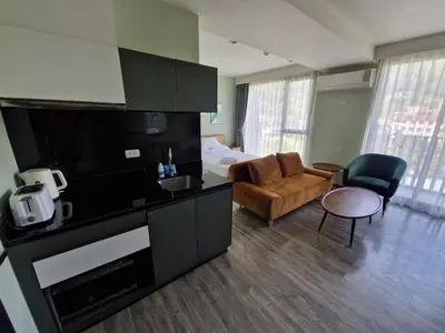a hotel room with a kitchen and a living room at The Deck Condo Patong 7th Fl Mountain View1 in Patong Beach