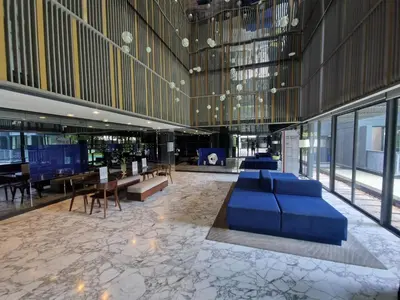 a lobby with a blue couch in a building at The Deck Condo Patong 7th Fl Mountain View1 in Patong Beach