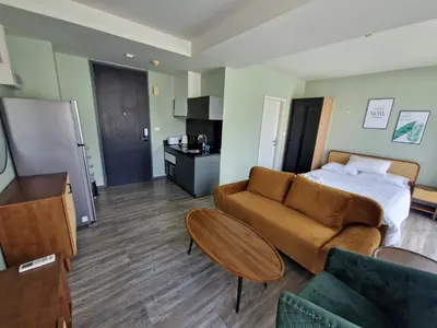 a hotel room with a bed and a couch at The Deck Condo Patong 7th Fl Mountain View1 in Patong Beach