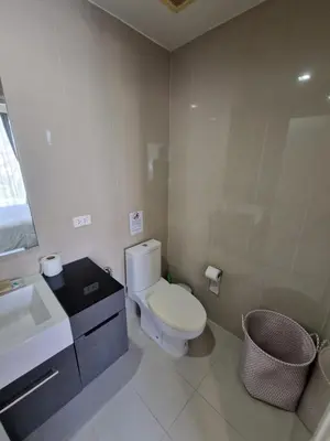 a bathroom with a white toilet and a sink at The Deck Condo Patong 7th Fl Mountain View1 in Patong Beach