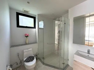 a bathroom with a shower and a toilet and a sink at Modern 2br apartment near Bangtao beach in Bang Tao Beach