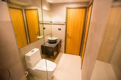 a bathroom with a white toilet and a sink at Title Rent Rawai in Rawai Beach
