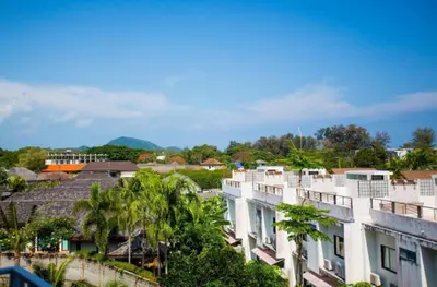 a view of a city with palm trees and buildings at Title Rent Rawai in Rawai Beach