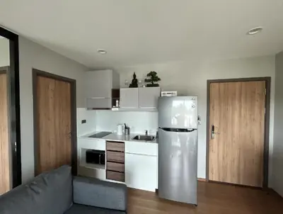 a kitchen with a stainless steel refrigerator in a room at Title Rent Rawai in Rawai Beach