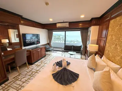 a hotel room with a bed and a television at Sea view apartment with jacuzzi at Patong Tower in Patong Beach