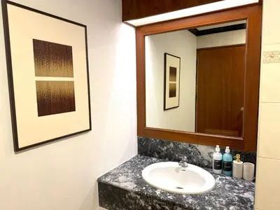 a bathroom with a sink and a mirror at Sea view apartment with jacuzzi at Patong Tower in Patong Beach