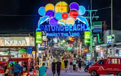 a crowd of people walking down a busy street at night at Sea view apartment with jacuzzi at Patong Tower in Patong Beach