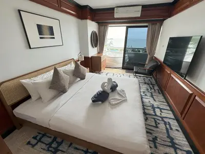 a bedroom with a large bed with towels on it at Sea view apartment with jacuzzi at Patong Tower in Patong Beach
