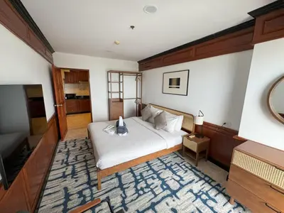 a bedroom with a large bed and a television at Sea view apartment with jacuzzi at Patong Tower in Patong Beach