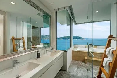 a bathroom with two sinks and a tub and a window at Villa W Luxury in Nai Harn Beach