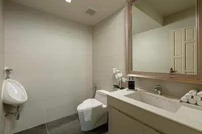 a bathroom with a sink and a toilet and a mirror at Villa W Luxury in Nai Harn Beach