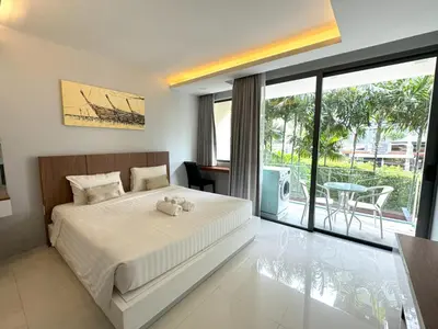 a bedroom with a large bed and a balcony at Peaceful Rawai studio with washer by Lofty in Rawai Beach