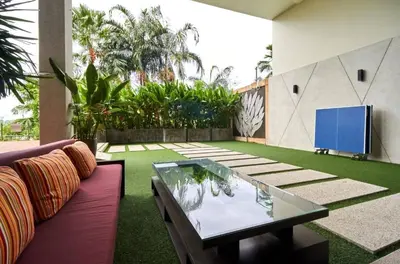 a living room with a couch and a glass table at Peaceful Rawai studio with washer by Lofty in Rawai Beach
