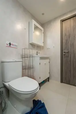 a bathroom with a toilet and a wooden door at С1O Новые Рубль ватсап669З582I976 in Nai Yang Beach