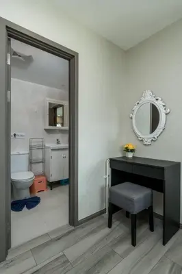 a bathroom with a table and a toilet and a mirror at С1O Новые Рубль ватсап669З582I976 in Nai Yang Beach