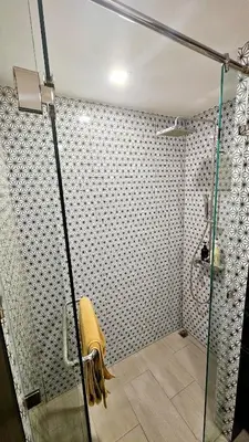 a shower with a glass door in a bathroom at Stylish Apartment with Workspace 10 Minutes from the Beach for min 30 Day Stays in Phuket Town