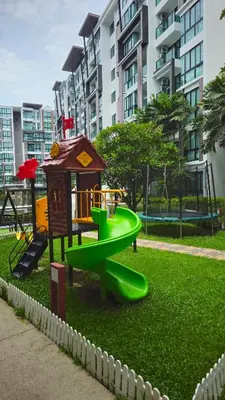a playground in a park with a green slide at Stylish Apartment with Workspace 10 Minutes from the Beach for min 30 Day Stays in Phuket Town