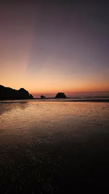 a sunset on a beach with the ocean at Stylish Apartment with Workspace 10 Minutes from the Beach for min 30 Day Stays in Phuket Town