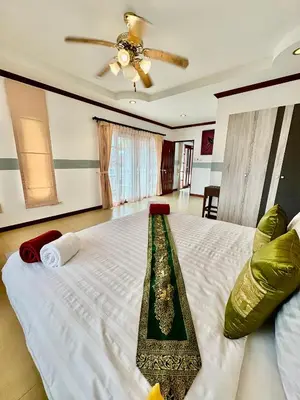 a bedroom with a large bed with a ceiling at Amazing 4BR pool villa near beach Bangtao in Ban Thalat Choeng Thale