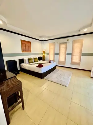a large bedroom with a bed and a desk at Amazing 4BR pool villa near beach Bangtao in Ban Thalat Choeng Thale