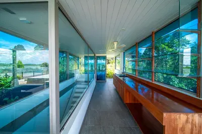 an empty house with a pool and large windows at Mai Khao Beach Luxury 7-bedroom villa 0 meters from the sea double infinity pool maid, outdoor wedding sea fishing in Mai Khao Beach