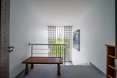a wooden bench in a room with a window at Mai Khao Beach Luxury 7-bedroom villa 0 meters from the sea double infinity pool maid, outdoor wedding sea fishing in Mai Khao Beach