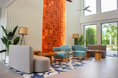 a waiting area with chairs and tables in a lobby at Lakeside Residences by NLA in Bang Tao Beach