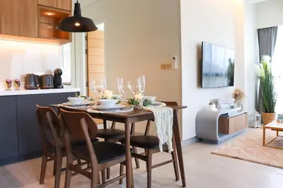 a dining room table and chairs in a kitchen at Lakeside Residences by NLA in Bang Tao Beach