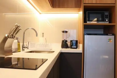 a small kitchen with a sink and a refrigerator at Lakeside Residences by NLA in Bang Tao Beach