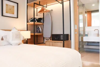 a bedroom with a bed and a tv and a mirror at Lakeside Residences by NLA in Bang Tao Beach