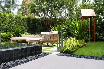 a garden with a bench and a gazebo at Lakeside Residences by NLA in Bang Tao Beach