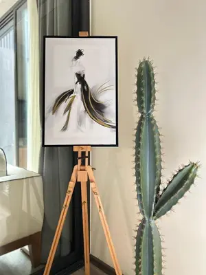 a painting on a tripod next to a cactus at The Deck Patong - Bangla in Patong Beach