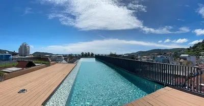 a swimming pool on the roof of a building at The Deck Patong - Bangla in Patong Beach