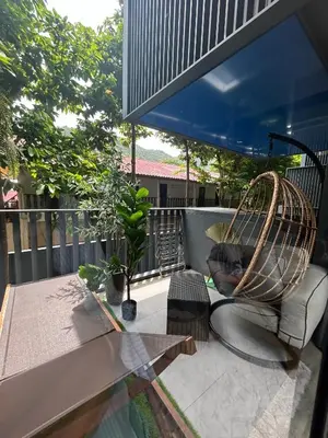 a cat sitting on a couch on a patio at The Deck Patong - Bangla in Patong Beach