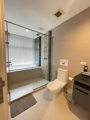 a bathroom with a toilet and a glass shower at The Deck Patong - Bangla in Patong Beach