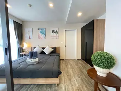 a bedroom with a bed and a potted plant at The Deck Patong - Bangla in Patong Beach