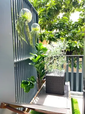 a black fence with a table and plants on it at The Deck Patong - Bangla in Patong Beach