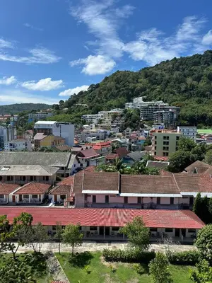 a city with buildings and a mountain in the background at The Deck Patong - Bangla in Patong Beach