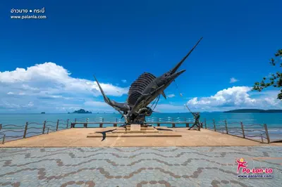 a statue of a bird sitting on top of the ocean at XX Bao Pathong Beach เบา ภูเก็ต หาดป่าตอง in Patong Beach