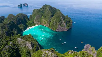 an aerial view of a island with boats in the water at XX Bao Pathong Beach เบา ภูเก็ต หาดป่าตอง in Patong Beach