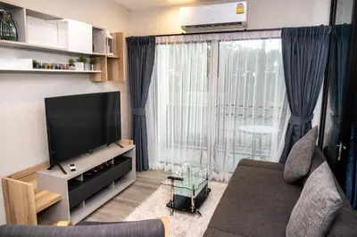 a living room with a couch and a flat screen tv at G14 SuperKingSizeBed 1этаж тихая сторона in Nai Yang Beach