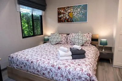 a bedroom with a bed with a red and white bedspread at G14 SuperKingSizeBed 1этаж тихая сторона in Nai Yang Beach